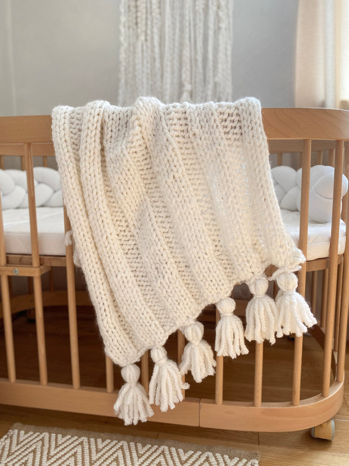 Boho knitted white baby blanket by Anzy home. baby shower gift for baptism or pregnancy congrats, for newborn photo props or as an expecting mom gift box.