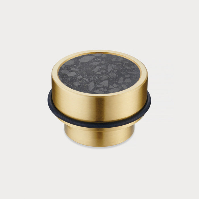 Brass & Black Terrazzo Floor Mounted Door Stops in Gold – installed view
