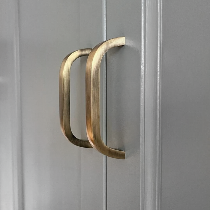 Brass Curved Cabinet Handles in Antique – product view 4
