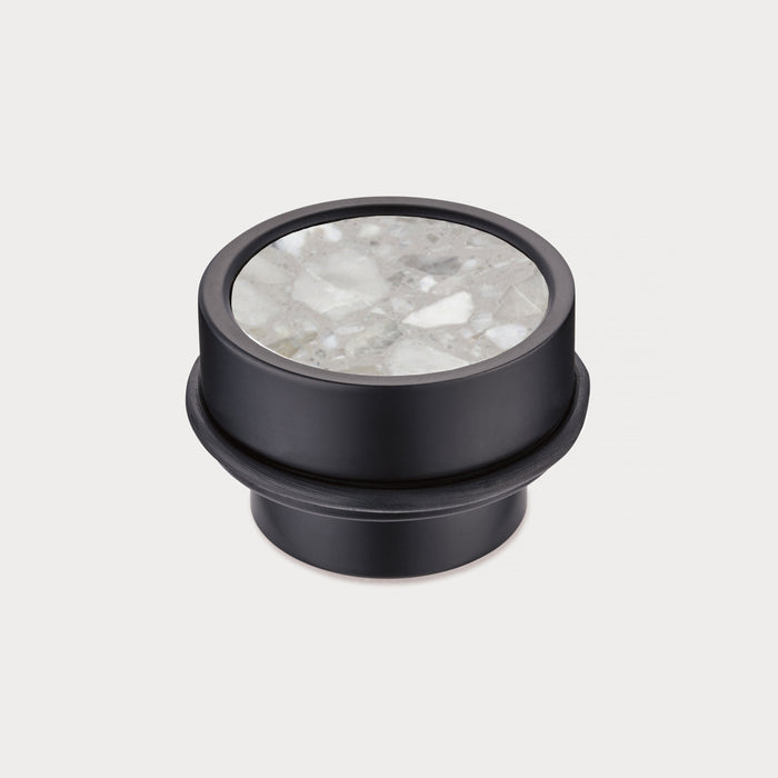 Brass & Grey Terrazzo Floor Mounted Door Stops in Black – installed view