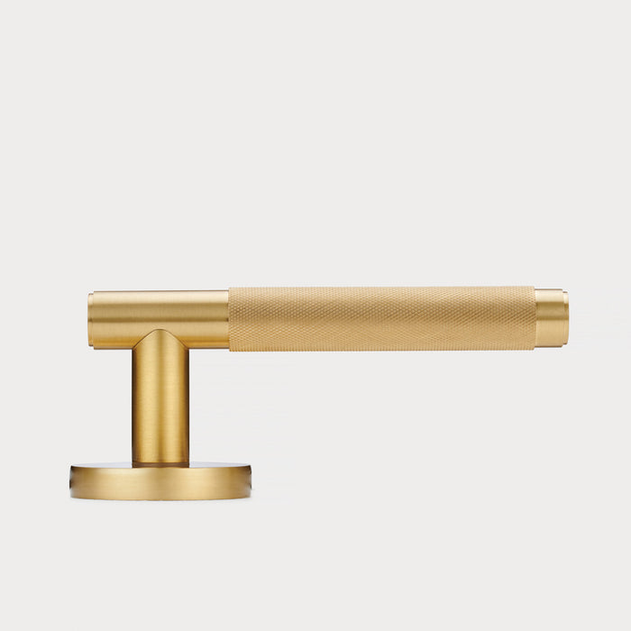Brass Knurled Lever Door Handle in Gold – installed view