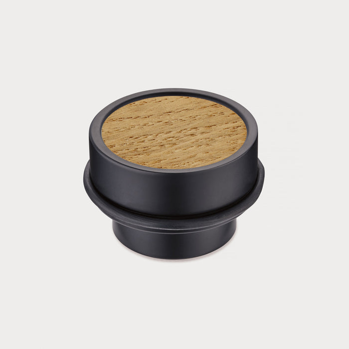 Brass & Oak Wood Floor Mounted Door Stops in Black – installed view