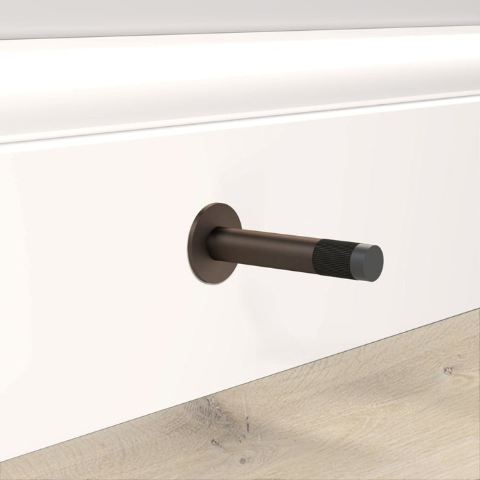 Bronze Linear Wall Mounted Door Stop in Black – installed view