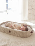 Baby resting in a beige crocheted XL lounging and changing basket – Anzy Home