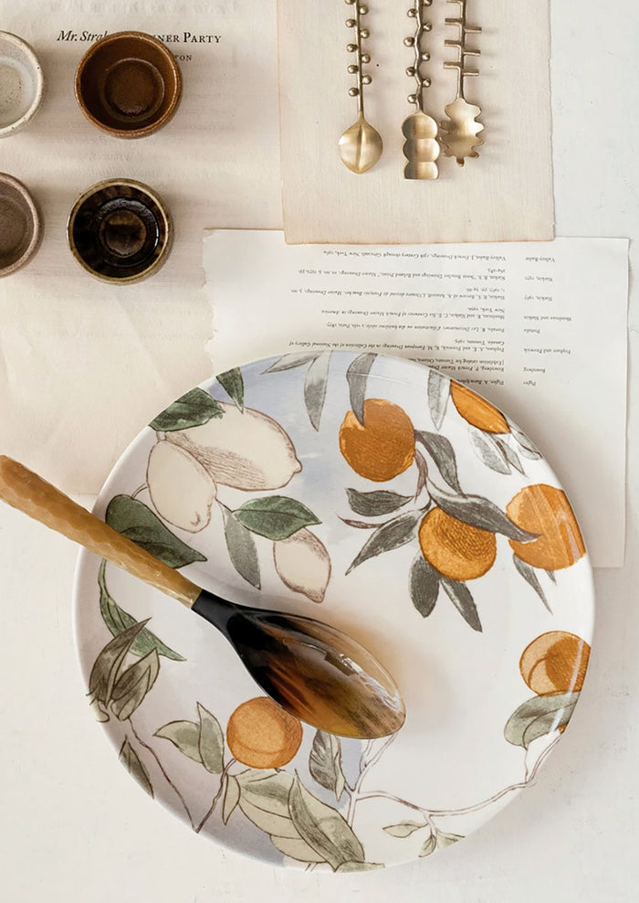 A round platter with orchard citrus print.