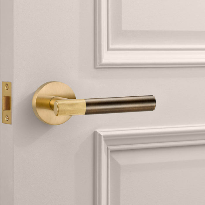 Gold Linear Lever Handle with Tip in Antique – installed view