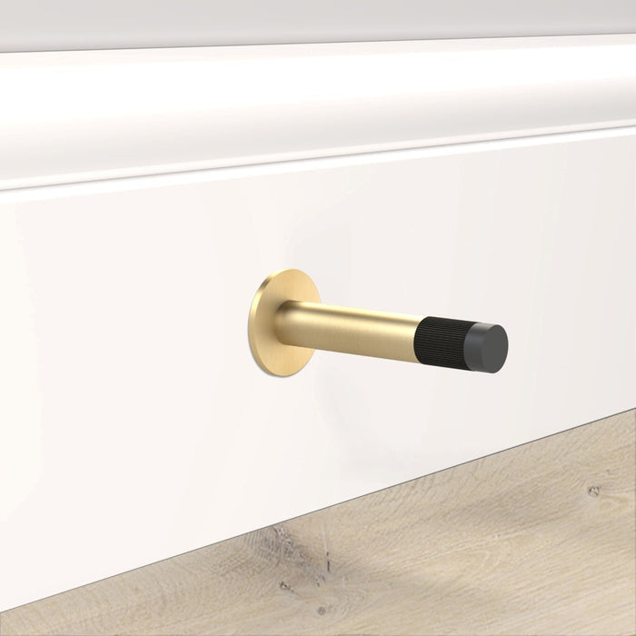 Gold Linear Wall Mounted Door Stop in Black – installed view