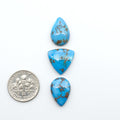 Golden Hills Turquoise cabochons, icy blue to lavender tones with chocolate matrix, polished stones on a white background with a US dime for scale