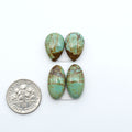 Number 8 Turquoise cabochons, blue and green color with brown matrix, polished stones on a white background, with a US dime for scale