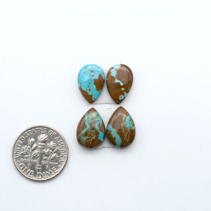 Number 8 Turquoise cabochons, blue and green color with brown matrix, polished stones on a white background, with a US dime for scale