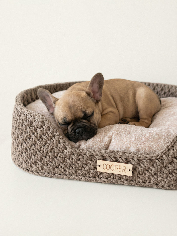 Handcrafted beige dog bed with french bulldog resting comfortably
