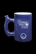 Blue ceramic mug with a built-in glass pipe bowl and text reading “Premium Roast & Toast.”